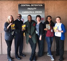 D. Watkins stands outside the jail with Free Minds and Department of Corrections staff