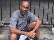 Rod sitting on a stoop in front of flowers