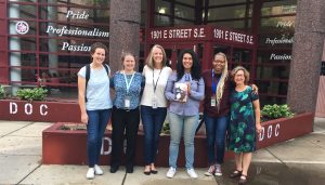 Elizabeth Acevedo stands in front of the DC Jail with Free Minds and An Open Book staff