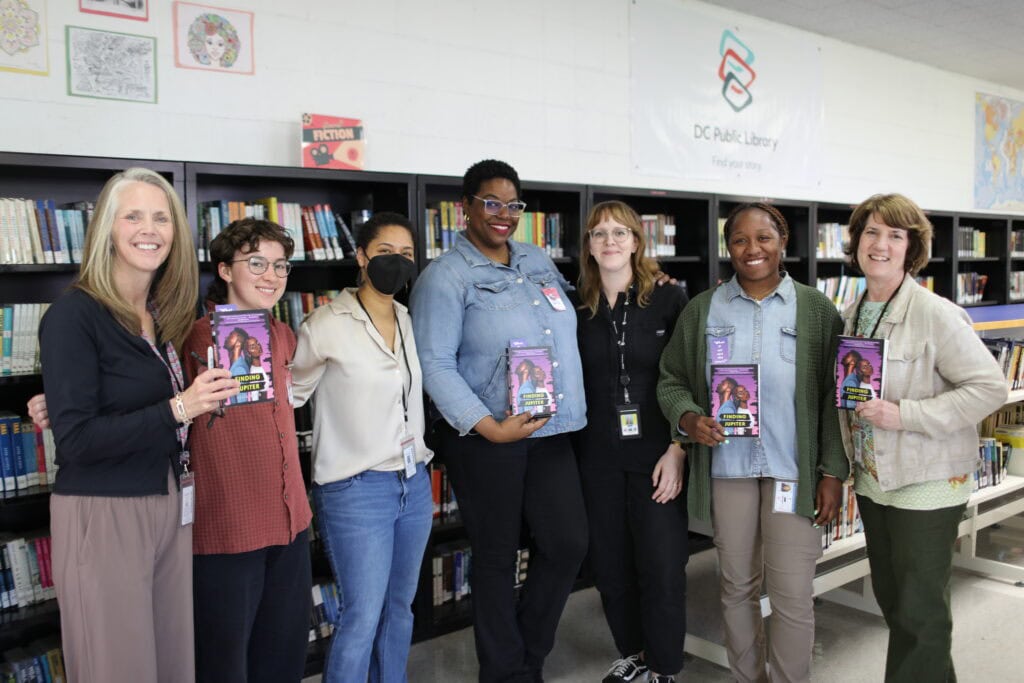 A group photo with author Kelis Rowe and staff from Free Minds and the DC Department of Corrections at the Women's Book Club.