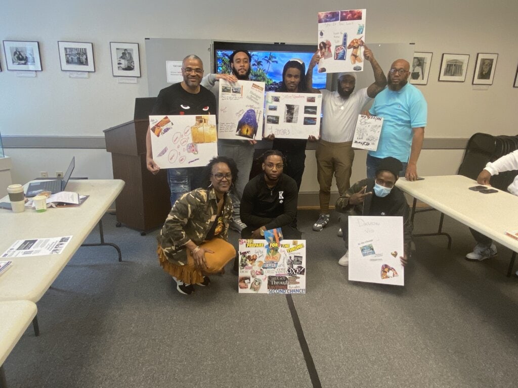 Free Minds members holding up their vision boards from the apprenticeship