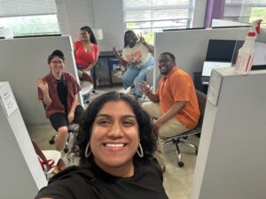 Members of the Free Minds staff in the office, smiling at the camera